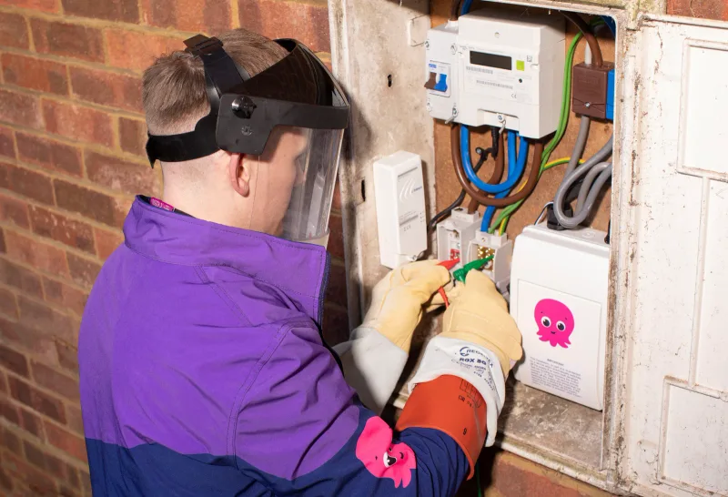 An Octopus Energy engineer working on a household electricity meter.