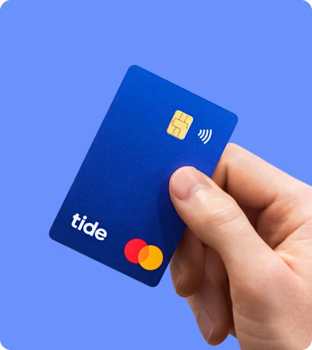 A blue Tide debit card held against a blue background.